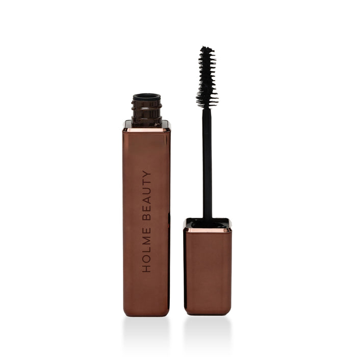 Brown mascara with black wand on a white background, branded 'Holme Beauty'.